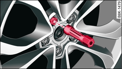 Changing a wheel: Hexagonal socket in screwdriver handle to turn the wheel bolts after they have been loosened